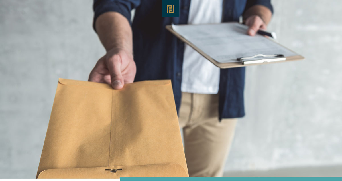 Close-up of envelope in hand of professional courier delivering divorce papers.