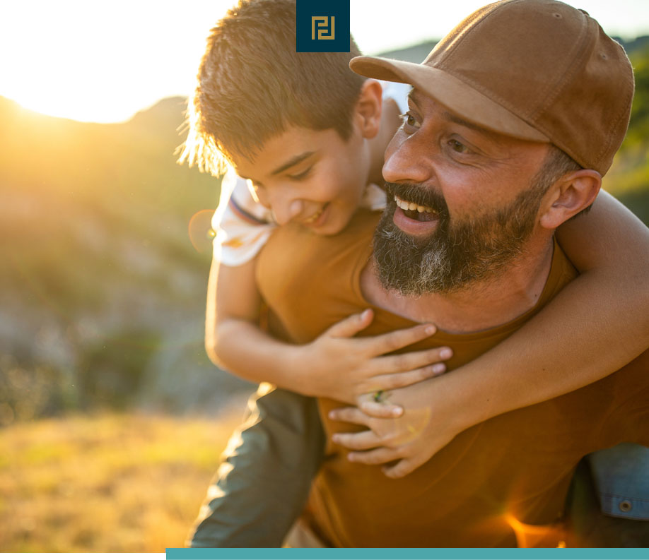 father with child on back outdoors