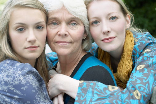 Grandmother, mother and daughter hugging