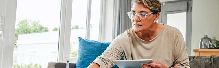 woman on couch reviewing paperwork