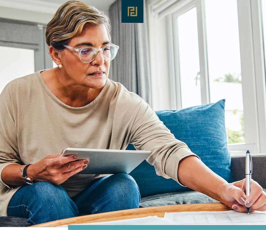 woman on couch reviewing paperwork