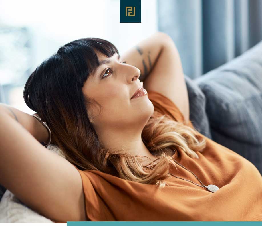 woman relaxing on sofa in home