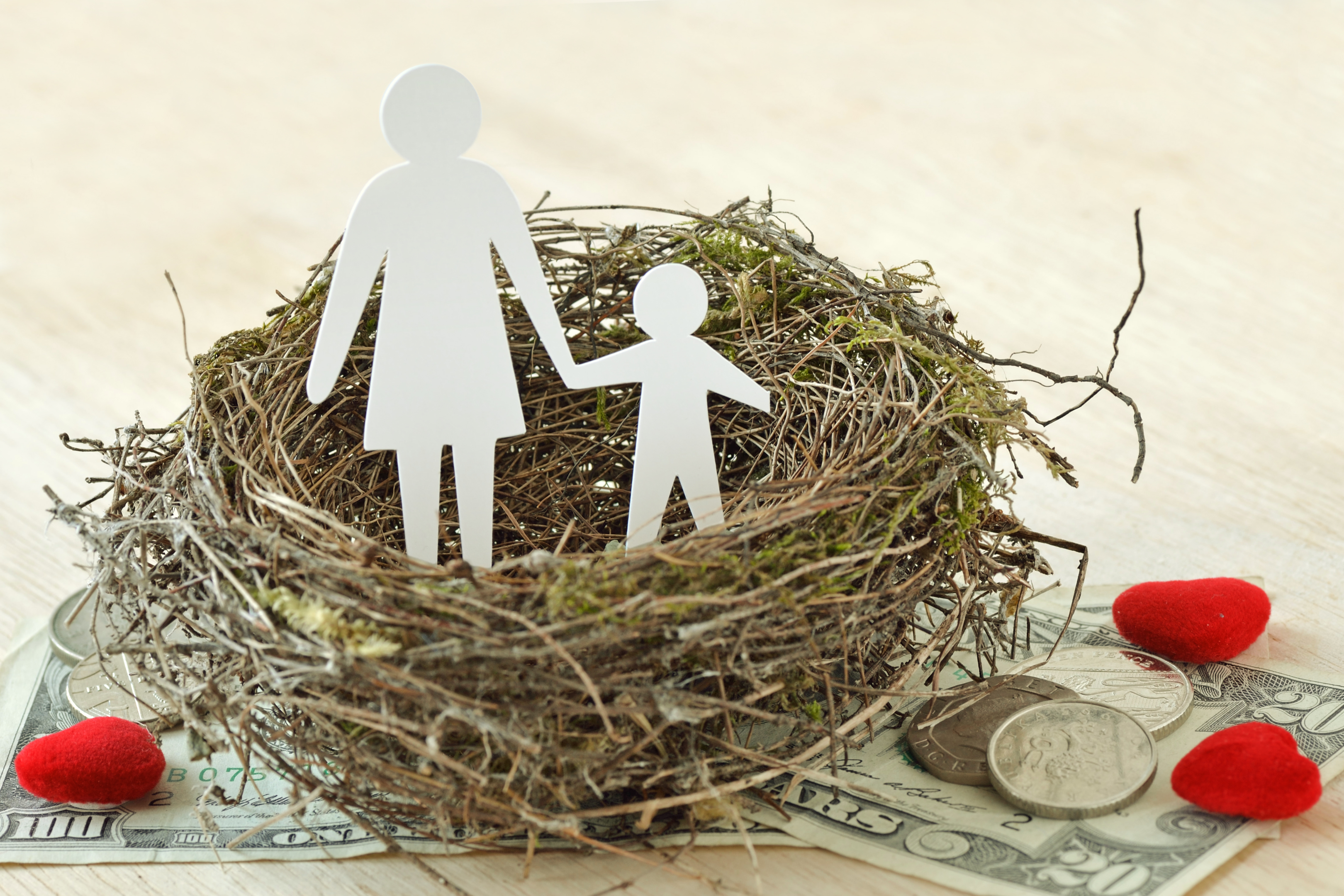 Nest with paper cutout of adult and child symbolic of alimony payments in Pennsylvania